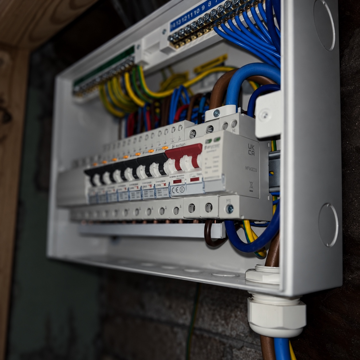 Close-up of a consumer unit with neatly routed wiring and protective devices